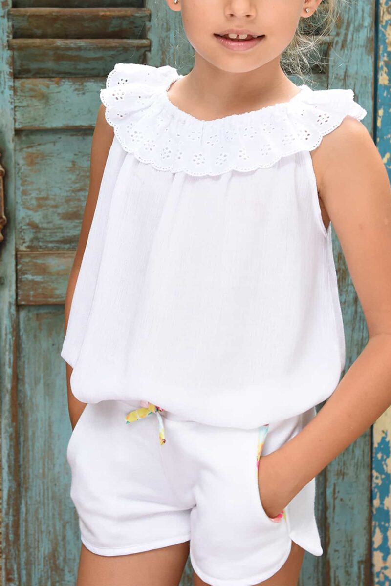 White cotton fleece shorts with elastic waistband and pockets lined with multicolored floral cotton for girls 2 to 12 years old